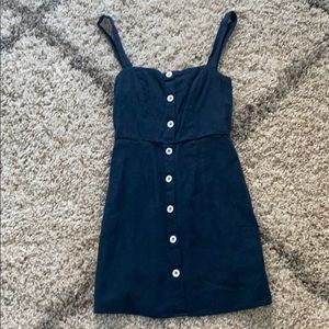 navy blue dress with white buttons down the front